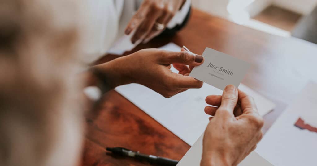 Woman Handing Off Her Business Card