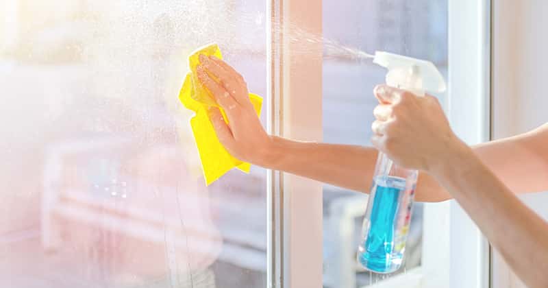 Cleaning Pro Wiping Down a Window