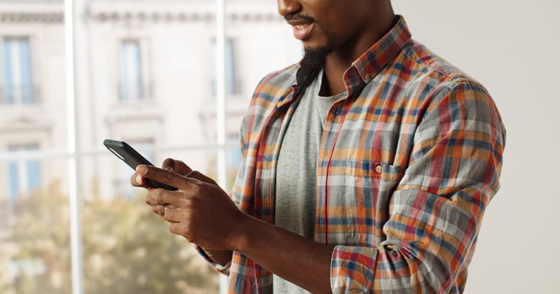 Contractor Doing Social Media Marketing on His Smartphone