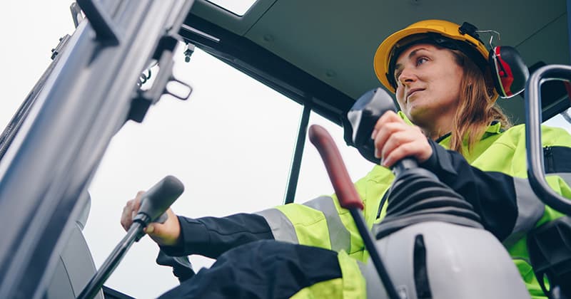 Female Construction Worker Operating Heavy Machinery