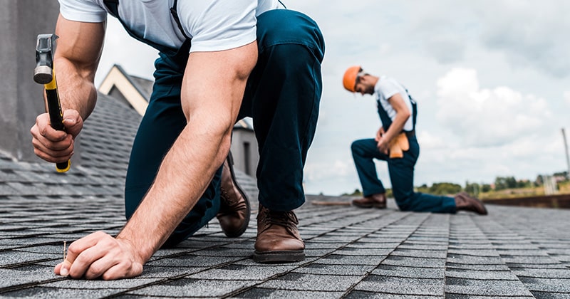Two Roofers Working on a Roof