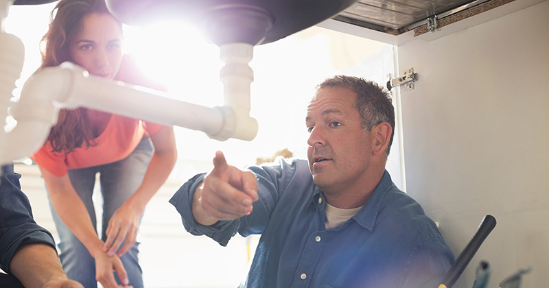 Residential Plumber Talking to a Homeowner