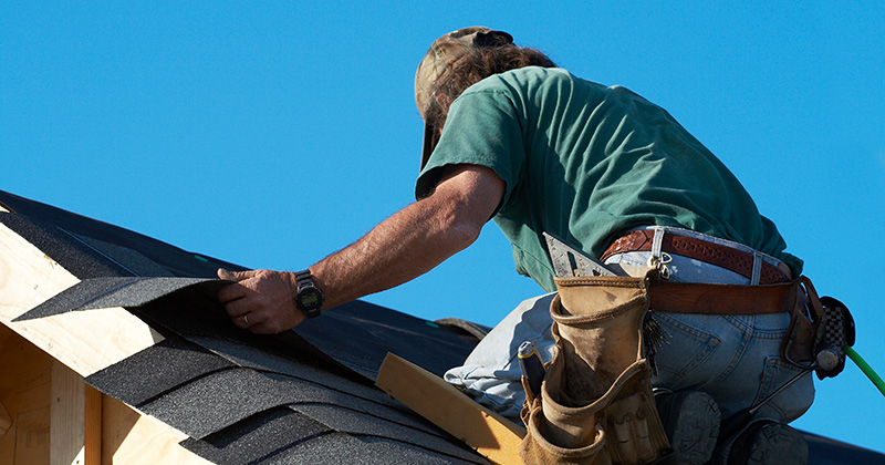 Roofer Laying Out Asphalt Shingles