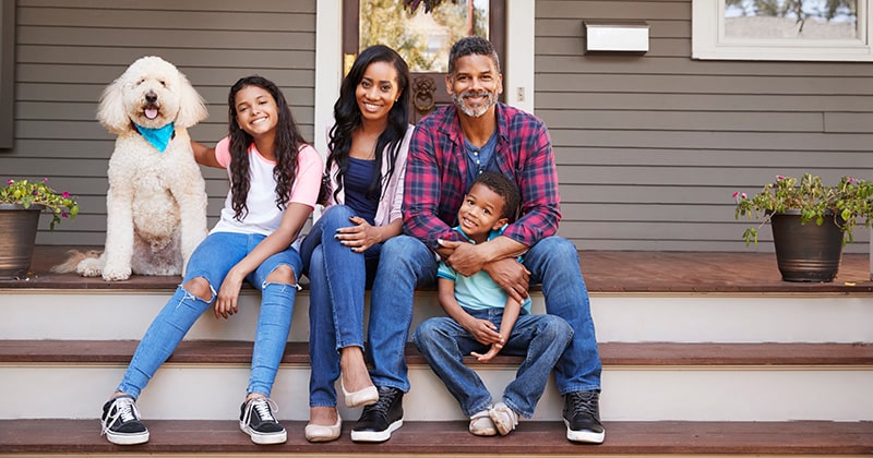 Happy Family Sitting on Their Front Porch