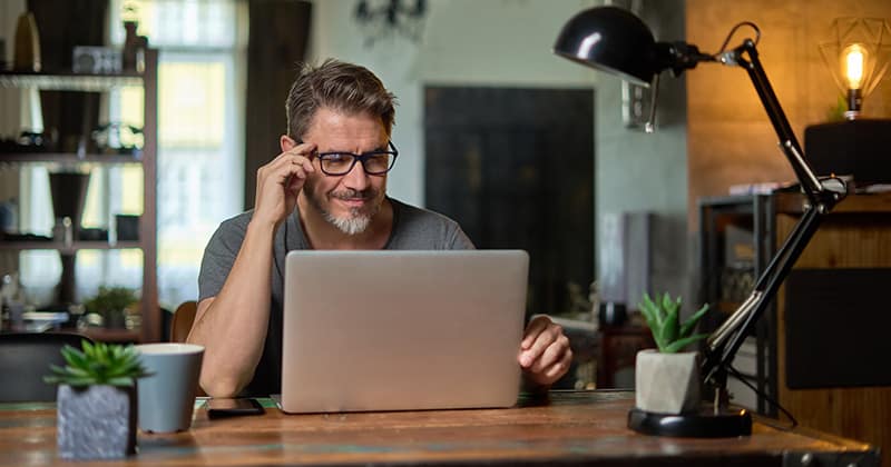 Man Working with Estimating Software on a Laptop