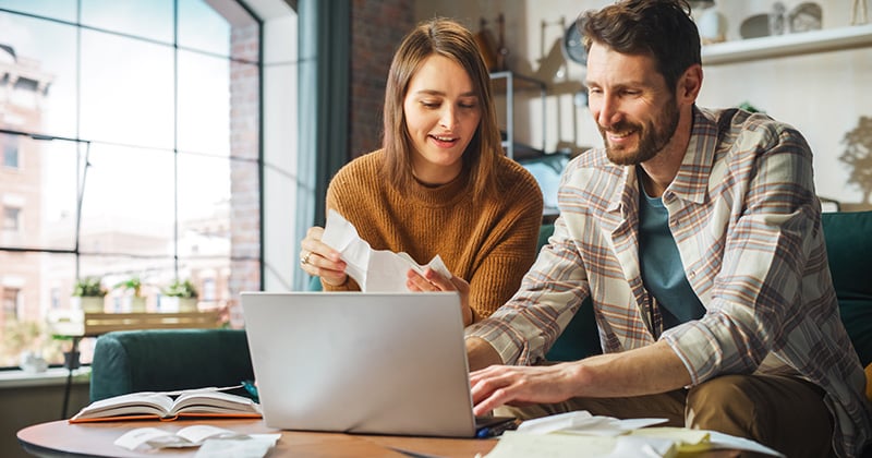 Man and Woman Working Together on a Laptop