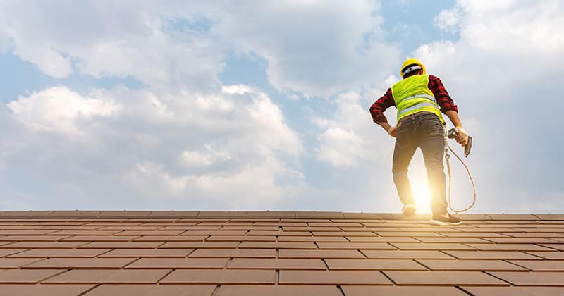 Roofer Looking at the Sunrise from a Rooftop