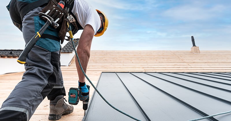 Roofer Working on a Metal Roof