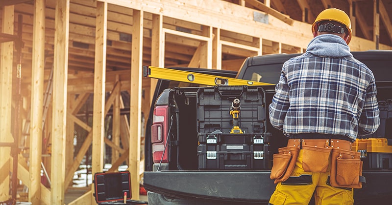 A Contractor Beside a Pickup Truck