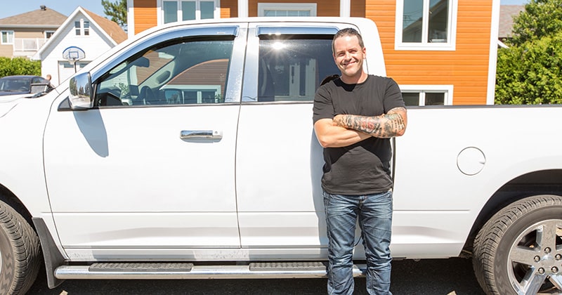A Home Services Pro Smiling Beside a Fleet Pickup Truck