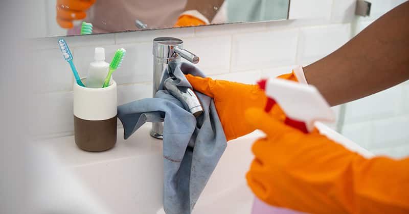 Residential Cleaning Pro Cleaning a Bathroom Sink