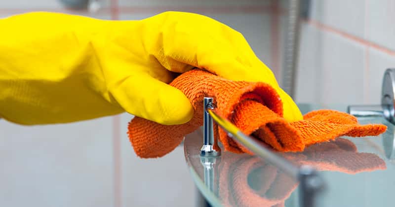 Residential Cleaning Pro Wiping Down a Shelf