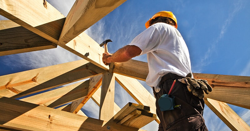 Construction Worker Working on a Frame