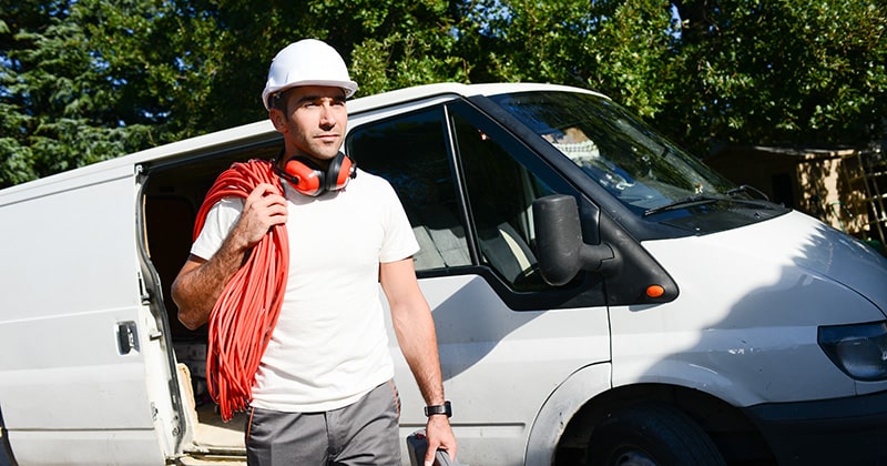 Electrician Beside His Fleet Van