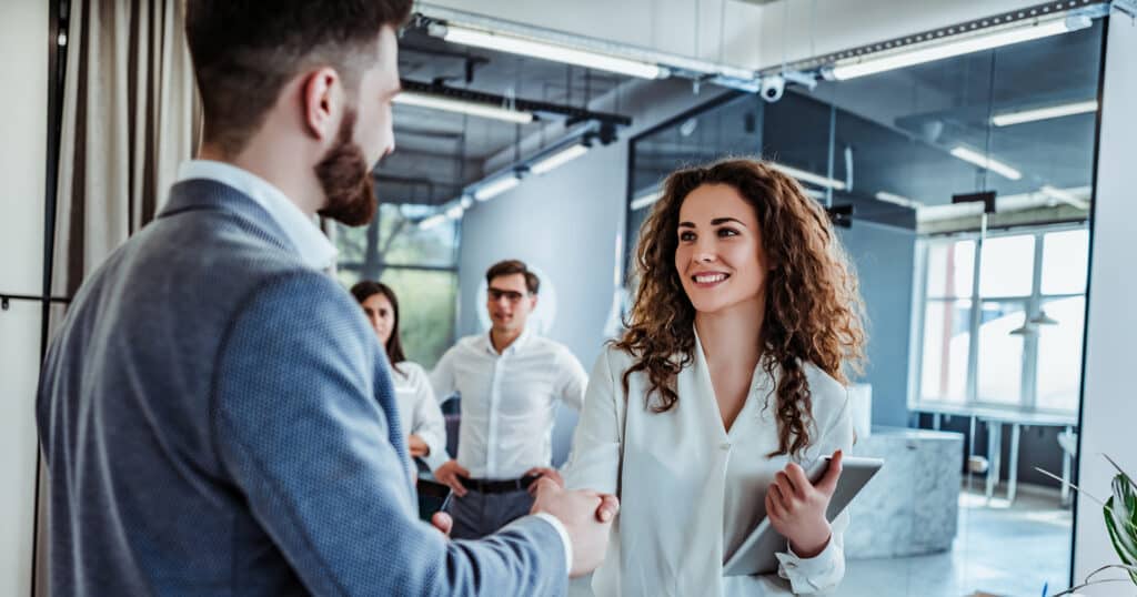 man-and-woman-shaking-hands-in-office