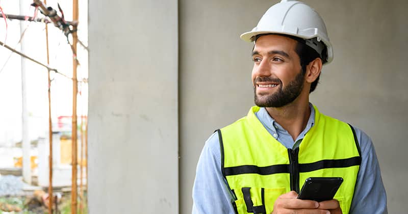 Landscaper on phone smiling