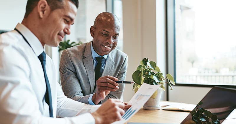 Two men reviewing accounting for home service provider