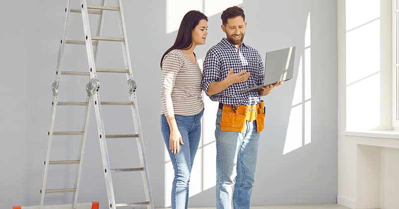 Contractor with laptop talking to customer