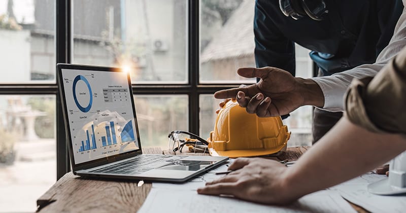 Electricians Looking at Results on Laptop