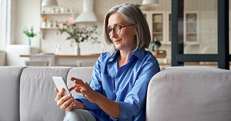 Older woman customer on phone in modern home