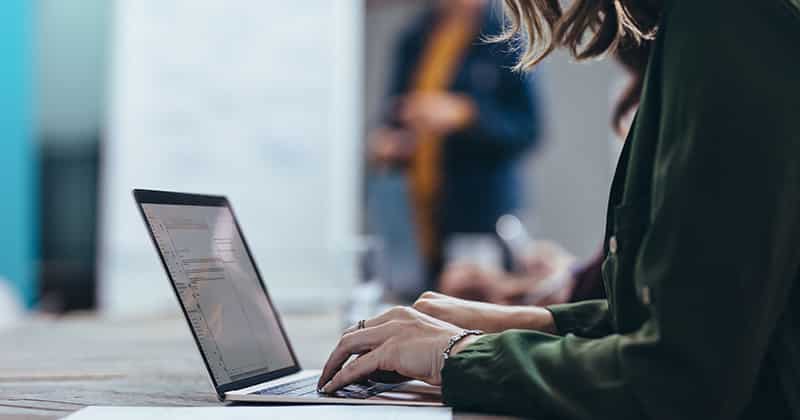 Woman working on email on laptop