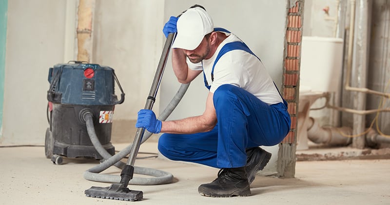 Worker using commercial vacuum on the job