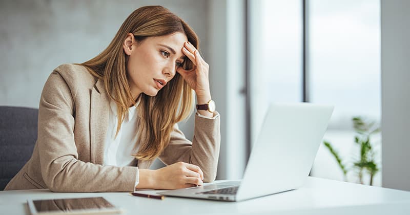 Stressed business woman looking at business reports