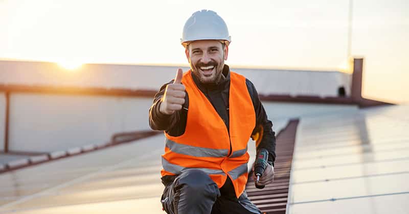 Roofer smiling with thumbs up