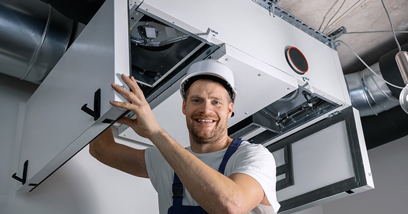 Smiling HVAC technician at work