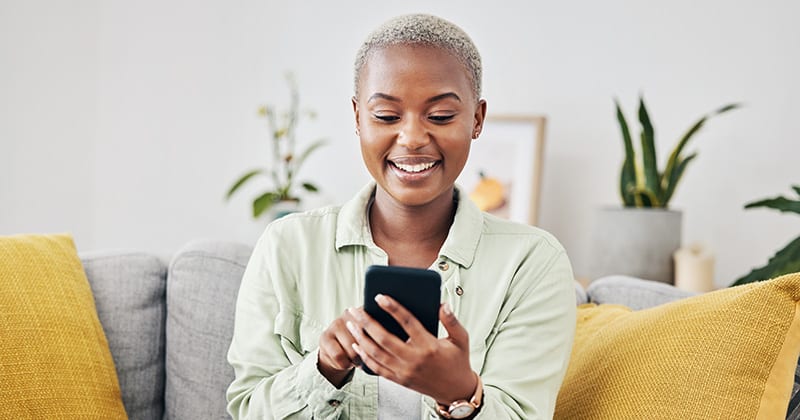 Woman smiling and scrolling on phone