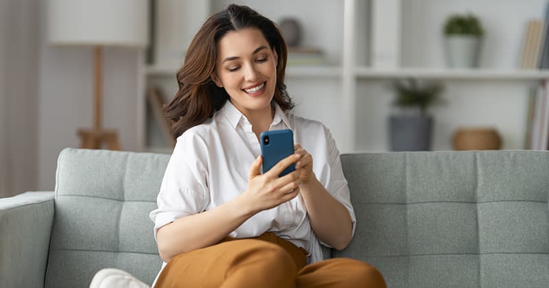 Woman smiling on smartphone