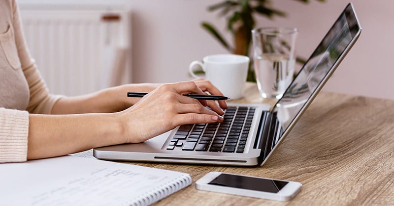 Women's hands typing on laptop