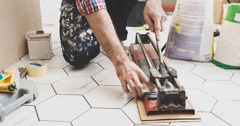Close up of flooring contractor using a tile cutter