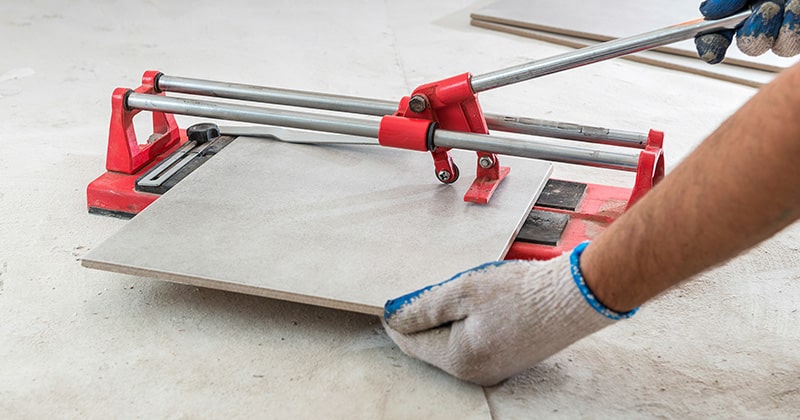 Flooring contractor uses a tile cutter