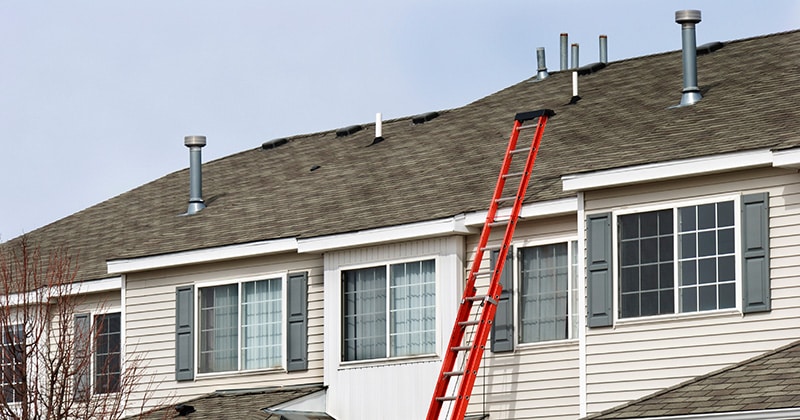 red ladder against white house