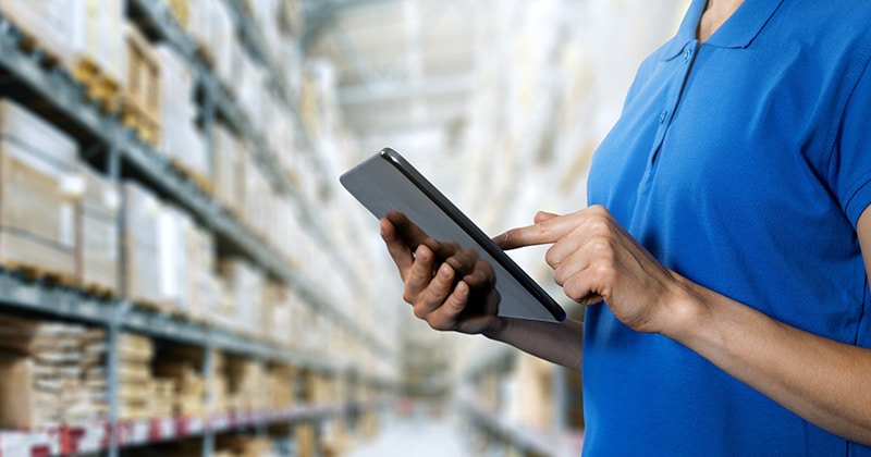 person with tablet choosing Inventory Management System