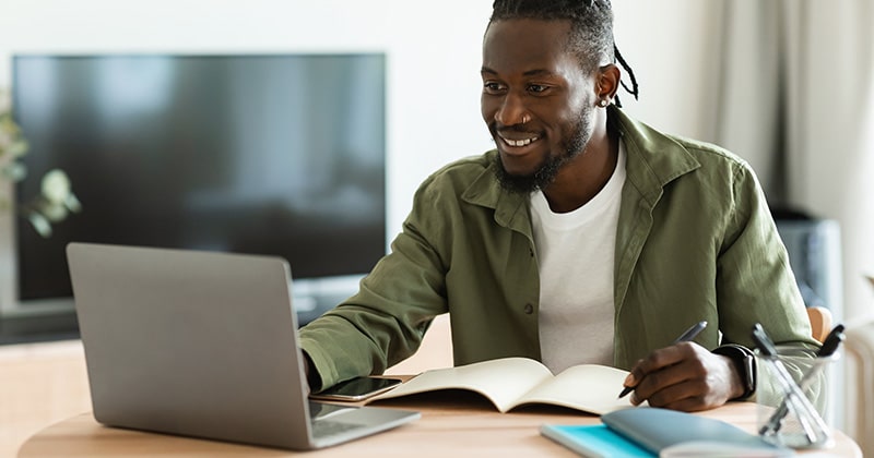 Man uses computer to boost local seo as contractor