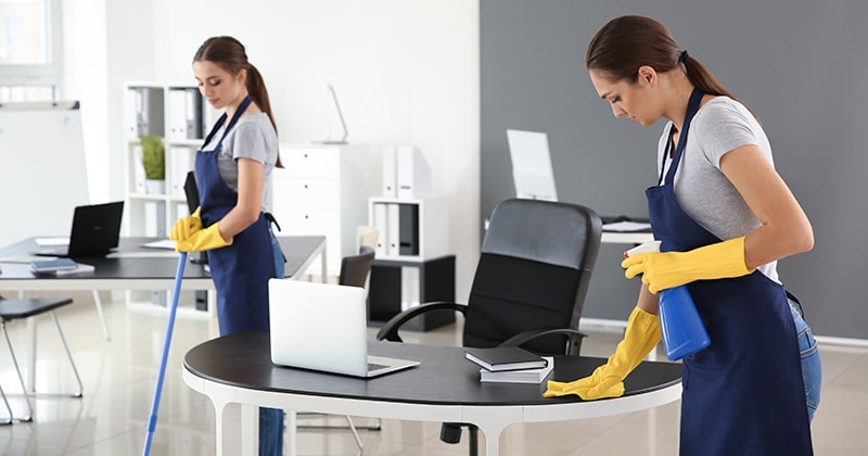 two women cleaning office