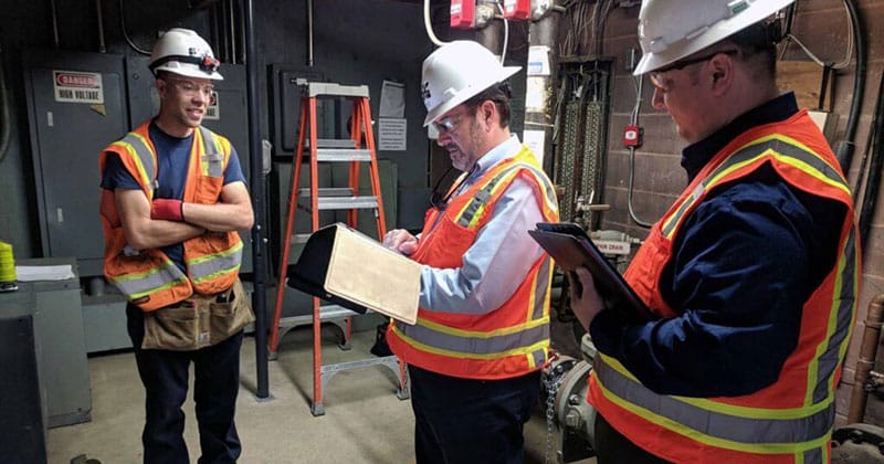 Construction safety team talking in warehouse