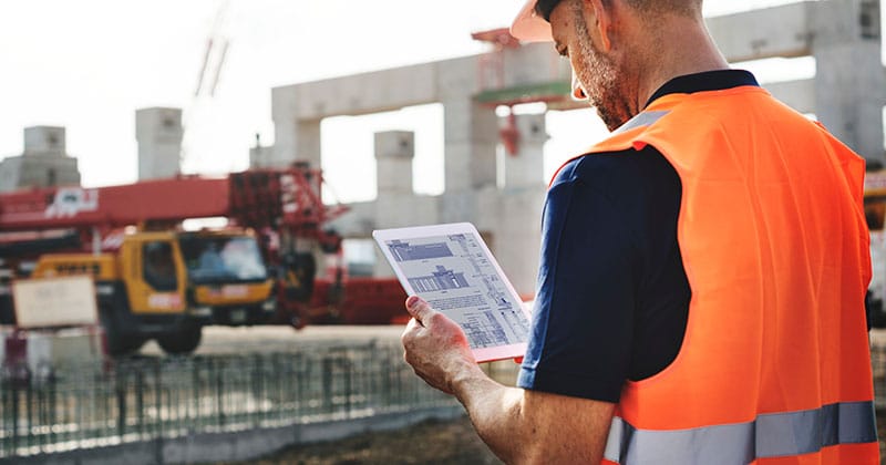Construction worker using tablet on work site